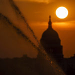 
              Sprinklers shoot jets of water along the National Mall as the sun rises behind the Capitol in Washington, Wednesday, Sept. 15, 2021. (AP Photo/J. Scott Applewhite)
            