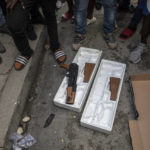 
              Protesters display toy guns used by musicians who were recording a music video the night before as they explain to journalists how police opened fire on the musicians killing one of them because police thought they were carrying real weapons, during a protest in downtown in Port-au-Prince, Haiti, Wednesday, Sept. 22, 2021. (AP Photo/Rodrigo Abd)
            