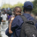 
              Haitian migrants use a dam to cross into and from the United States from Mexico, Saturday, Sept. 18, 2021, in Del Rio, Texas. The U.S. plans to speed up its efforts to expel Haitian migrants on flights to their Caribbean homeland, officials said Saturday as agents poured into a Texas border city where thousands of Haitians have gathered after suddenly crossing into the U.S. from Mexico. (AP Photo/Eric Gay)
            