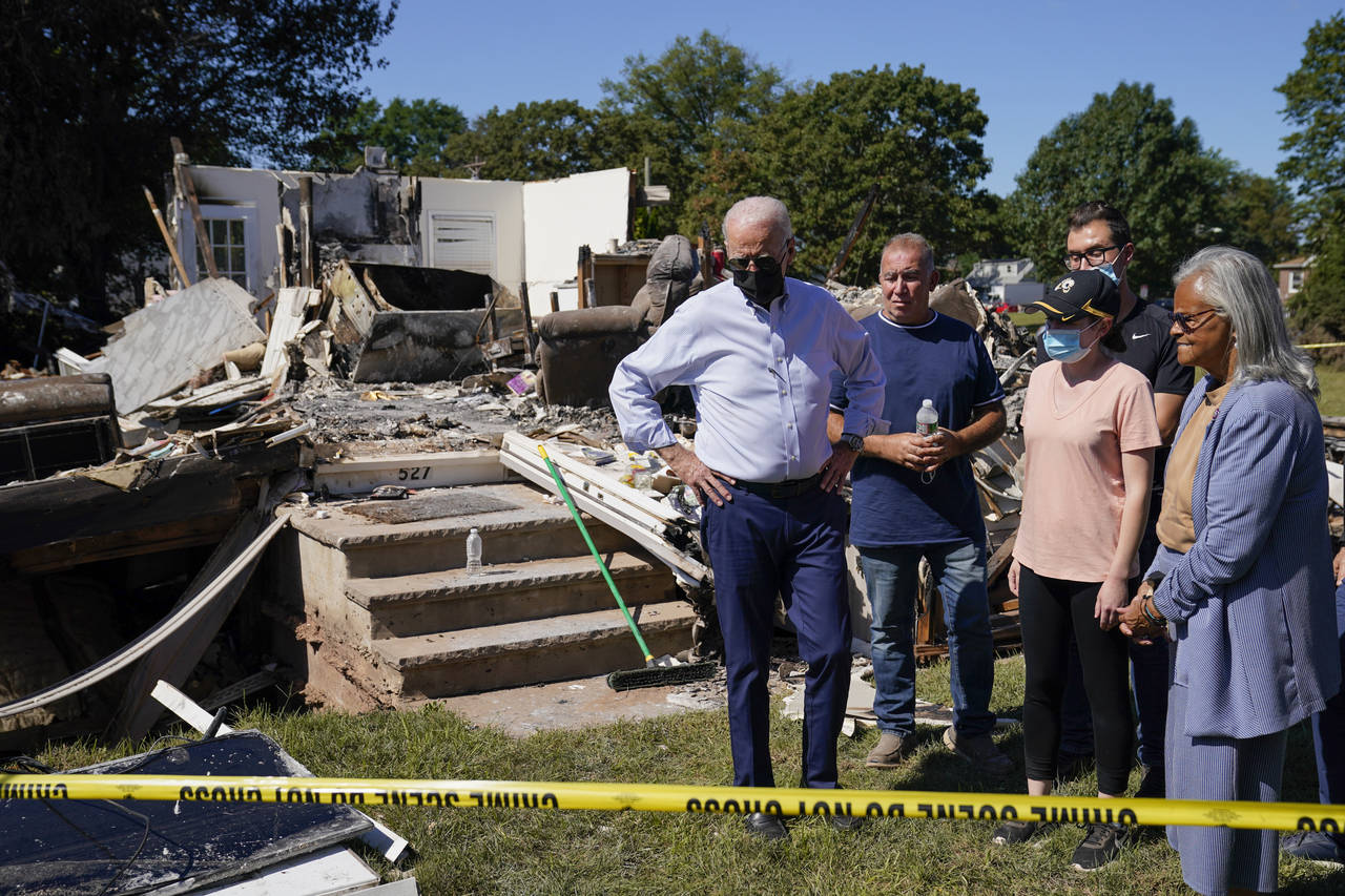 FILE - In this Sept. 7, 2021, file photo President Joe Biden tours a neighborhood impacted by Hurri...