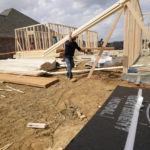 
              In this March 16, 2021 photo, a workman carries beamS at a new housing site in Madison County, Miss.  Rising costs and shortages of building materials and labor are rippling across the homebuilding industry, which accounted for nearly 12% of all U.S. home sales in July. Construction delays are common, prompting many builders to pump the brakes on the number of new homes they put up for sale. As building a new home gets more expensive, some of those costs are passed along to buyers. (AP Photo/Rogelio V. Solis)
            