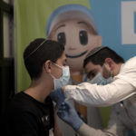 
              A 14-year-old Israeli receives a booster shot of the coronavirus vaccine at Clalit Health Service's center in the Cinema City complex in Jerusalem, Wednesday, Sept. 22, 2021. Israel is pressing ahead with its aggressive campaign offering coronavirus booster shots to almost anyone over 12, even after U.S. regulators called for limiting them to older patients or those at higher risk. (AP Photo/Maya Alleruzzo)
            
