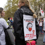 
              A medical worker holds a placard reading : "Money for Hospital, Not for the Capital, Our Solution Hospitals beds, Employs and quick", during a protest gathering outside the Health Ministry, in Paris, Tuesday, Sept. 14, 2021 against a law requiring them to get vaccinated by Wednesday or risk suspension from their jobs. The law is aimed at protecting patients from new surges of COVID-19. Most of the French population is vaccinated but a vocal minority are against the vaccine mandate. (AP Photo/Francois Mori)
            
