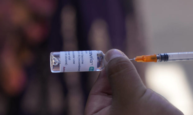 A healthcare worker prepares a dose of the AstraZeneca COVID-19 vaccine during a door-to-door vacci...