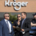 
              Law enforcement officers confer at the scene following a shooting at a Kroger's grocery store in Collierville, Tenn., on Thursday, Sept. 23, 2021. (Patrick Lantrip/Daily Memphian via AP)
            