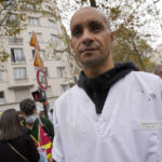 
              Rachid Ouchem, a medical worker from the Plaisir Hospital, attends a protest gathering outside the Health Ministry in Paris, Tuesday, Sept. 14, 2021 against a law requiring them to get vaccinated by Wednesday or risk suspension from their jobs. The law is aimed at protecting patients from new surges of COVID-19. Most of the French population is vaccinated but a vocal minority are against the vaccine mandate. (AP Photo/Francois Mori)
            