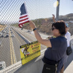 
              Volunteers wave flags and hold recall Gov. Gavin Newsom signs along the I-14 freeway at Golden Valley road in Santa Clarita, Calif., Monday, Sept. 13, 2021. Voting concludes Tuesday in California's recall election. (David Crane/The Orange County Register via AP)
            