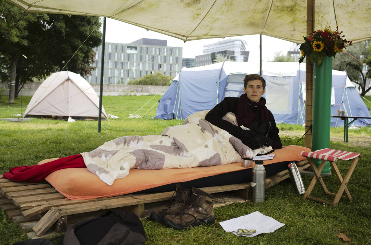Climate activist Henning Jeschke, who is since 24 days on a hunger strike, lays on a mattress under...