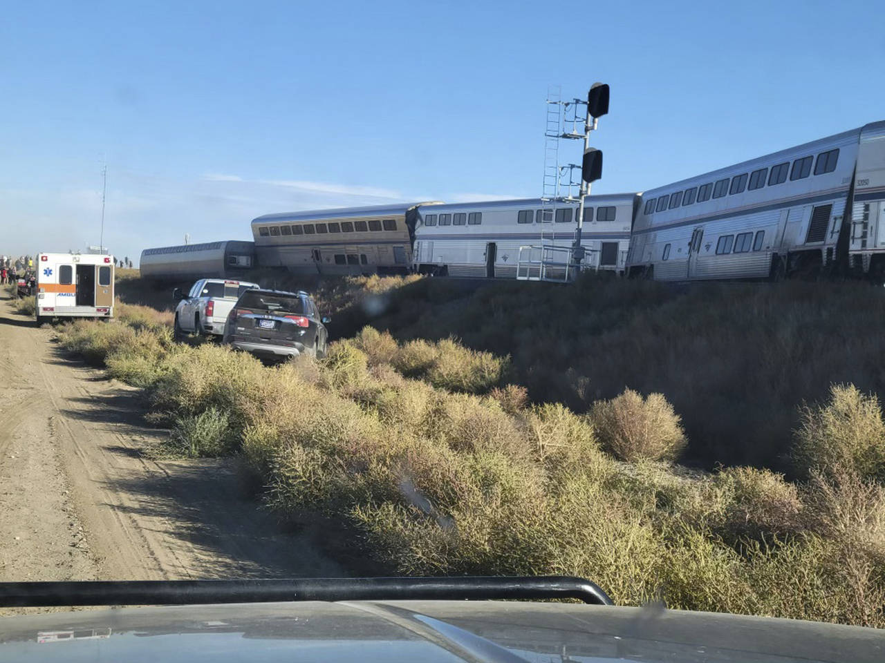 In this photo provided by Kimberly Fossen an ambulance is parked at the scene of an Amtrak train de...
