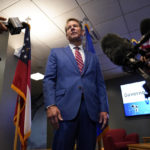 
              FILE - In this Aug. 26, 2021 file photo, Georgia Gov. Brian Kemp speaks during a news conference at Lockheed Martin  in Marietta, Ga. The rewards of an early Donald Trump endorsement will be on display Saturday, Sept. 25 in Georgia. A three-man ticket of candidates he’s backing in 2022 Republican primaries for statewide office will take the stage with him. (AP Photo/Brynn Anderson, File)
            