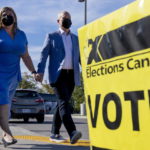 
              Conservative Leader Erin O'Toole and his wife Rebecca arrive to vote in the Canadian federal election in Bowmanville, Ontario on Monday, September 20, 2021. (Frank Gunn/The Canadian Press via AP)
            