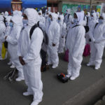 
              Healthcare workers, dressed in full protective gear, take part in a ceremony kicking off a door-to-door COVID-19 vaccination campaign, in El Alto, Bolivia, Thursday, Sept. 16, 2021. The workers will return Friday, bringing vaccinations directly to people's homes. (AP Photo/Juan Karita)
            