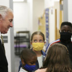 
              FILE - Camden Elementary School students in masks listen as South Carolina Gov. Henry McMaster talks to them on Wednesday, Sept. 15, 2021, in Camden, S.C.  A federal judge Tuesday, Sept. 28 suspended South Carolina from enforcing a rule that banned school districts from requiring masks for students. Parents of disabled children, helped by the American Civil Liberties Union, sued the state saying the ban discriminated against medically vulnerable students by keeping them out of public schools as the COVID-19 pandemic continues. The mask ban has been forcefully backed by McMaster and GOP lawmakers who said parents should decide whether students wear masks, not school officials.  (AP Photo/Jeffrey Collins, File)
            