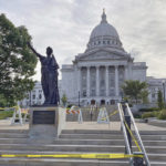 
              Workers reinstalled a statue Tuesday, Sept. 21, 2021 symbolizing Wisconsin's "Forward" motto outside the state Capitol in Madison, Wis. Protesters tore the 7-foot statue down during a demonstration in June 2020 over George Floyd's death in Minneapolis. (AP Photo/Todd Richmond)
            