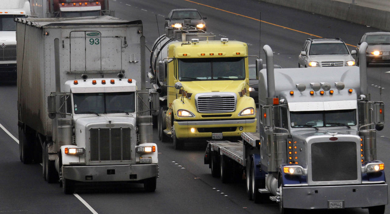FILE —11 In this Dec. 17, 2010 file photo, trucks make their way eastbound, in Livermore, Calif. ...