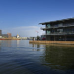 
              A dredger ship passes the Floating Office, right, where a high-Level dialogue on climate adaptation takes place in Rotterdam, Netherlands, Monday, Sept. 6, 2021. The dialogue, taking place just weeks before the COP26 UN climate change conference in Glasgow, will hammer out a clear call to action for governments, policy-makers and the public on what COP26 must deliver if communities are to be kept safe from the accelerating climate impacts in the coming decade. (AP Photo/Peter Dejong)
            