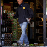 
              An FBI agent walks out the door of at a Kroger store in Collierville, Tenn., on Friday, Sept. 24, 2021.  Police say a gunman, who has been identified as a third-party vendor to the store, attacked people Thursday and killed at least one person and wounded others before being found dead of an apparent self-inflicted gunshot wound.(Patrick Lantrip/Daily Memphian via AP)
            