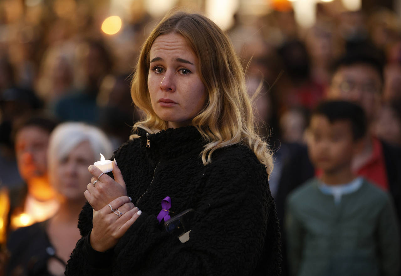 A woman cries as she attends a vigil for murdered 28-year-old teacher Sabina Nessa in Kidbrooke in ...