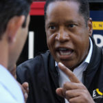 
              Republican conservative radio show host Larry Elder argues with a TV reporter during an interview after visiting Philippe The Original Deli during a campaign for the California gubernatorial recall election on Monday, Sept. 13, 2021, in Los Angeles. (AP Photo/Ringo H.W. Chiu)
            