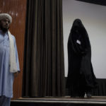 
              A woman walks down from the stage inside an auditorium at Kabul University's education center during a demonstration in support of the Taliban government in Kabul, Afghanistan, Saturday, Sept. 11, 2021. (AP Photo/Felipe Dana)
            