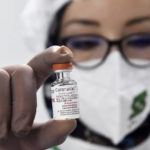 
              A person shows a dose of the CoronaVac COVID-19 vaccine at the Saidal factory in Constantine, Wednesday, Sept.29, 2021. Algeria's first home-produced coronavirus vaccines came off the assembly line Wednesday, as part of a cooperation deal with the makers of China's Sinovac vaccine. The "CoronaVac" vaccines were made at the Saidal factory in the Algerian city of Constantine, which authorities say is aiming to produce up to 5 million doses per month. (AP Photo)
            