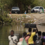 
              A Texas State Trooper ropes off an area along the banks of the Rio Grande as Haitian migrants use a dam to cross into the United States from Mexico, Saturday, Sept. 18, 2021, in Del Rio, Texas. U.S. officials said that within the next three days, they plan to ramp up expulsion flights for some of the thousands of Haitian migrants who have gathered in the Texas city from across the border in Mexico. (AP Photo/Eric Gay)
            