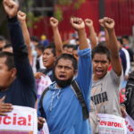 
              Supporters and relatives of 43 missing university students hold placards with photos of their loved ones as they march on the seventh anniversary of their disappearance, in Mexico City, Sunday, Sept. 26, 2021. Relatives continue to demand justice for the Ayotzinapa students who were allegedly taken from the buses by the local police and handed over to a gang of drug traffickers. (AP Photo/Marco Ugarte)
            