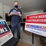 
              FILE - In this Oct. 6, 2020 file photo, redistricting reform advocate Brian Cannon poses with some of his yard signs and bumper stickers in his office in Richmond, Va.  A new voter-approved commission in Ohio that was supposed to reduce partisanship in the once-a-decade process of political map-drawing has already become a flop.  Similar commissions meeting for the first time in New York and Virginia have devolved into partisan finger-pointing, undermining their intent. (AP Photo/Steve Helber, File)
            
