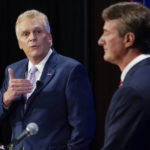 
              FILE - In this Sept. 16, 2021, file photo Democratic gubernatorial candidate former Governor Terry McAuliffe, left, gestures as Republican challenger, Glenn Youngkin, listens during a debate at the Appalachian School of Law in Grundy, Va. McAuliffe has generally led in public polling, but recent surveys have suggested his lead is tightening. His race against Glenn Youngkin is one of the country’s most competitive and closely watched political matchups of the year. (AP Photo/Steve Helber, File)
            