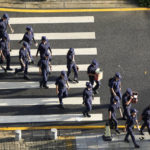 
              Security personnel march to their duty outside the Evergrande headquarters in Shenzhen, China, Friday, Sept. 24, 2021. Things appeared quiet at the headquarters of the heavily indebted Chinese real estate developer Evergrande, one day after the day it had promised to pay interest due to bondholders in China.(AP Photo/Ng Han Guan)
            