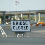 
              The International bridge where thousands of Haitian migrants have created a makeshift camp remains closed, Saturday, Sept. 18, 2021, in Del Rio, Texas. The Biden administration plans the widescale expulsion of Haitian migrants from a small Texas border city by putting them on on flights to Haiti starting Sunday, an official said Friday, representing a swift and dramatic response to thousands who suddenly crossed the border from Mexico and gathered under and around a bridge.(AP Photo/Eric Gay)
            