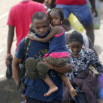 
              Haitian migrants use a dam to cross into and from the United States from Mexico, Saturday, Sept. 18, 2021, in Del Rio, Texas. The U.S. plans to speed up its efforts to expel Haitian migrants on flights to their Caribbean homeland, officials said Saturday as agents poured into a Texas border city where thousands of Haitians have gathered after suddenly crossing into the U.S. from Mexico. (AP Photo/Eric Gay)
            