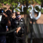 
              Memphis Police Department members gather in the parking lot  following a shooting at a Kroger's grocery store in Collierville, Tenn., on Thursday, Sept. 23, 2021. (Patrick Lantrip/Daily Memphian via AP)
            