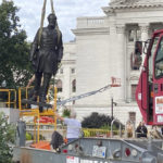 
              Workers reinstall a statue of Wisconsin abolitionist Col. Hans Christian Heg outside the state Capitol in Madison, Wis., on Tuesday, Sept. 21, 2021. Protesters tore the 9-foot-6-inch statue down and ripped its head off in June 2020 during a demonstration over George Floyd's death in Minneapolis. (AP Photo/Todd Richmond)
            