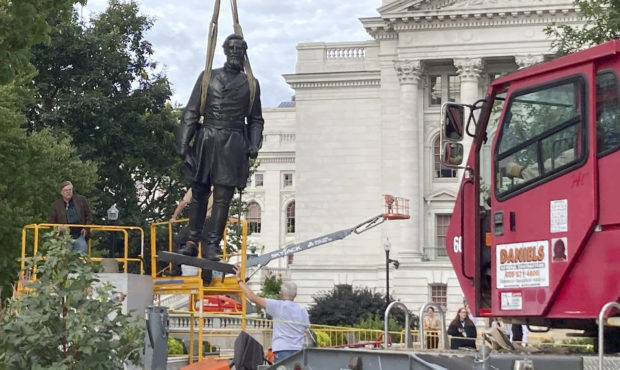 Workers reinstall a statue of Wisconsin abolitionist Col. Hans Christian Heg outside the state Capi...