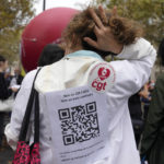 
              A medical worker wearing a paper reading "No to QR code, No to Health Pass , the vaccin does not prevent for the virus transmission, Freedom to choose to be vaccinated" during a protest gathering outside the Health Ministry in Paris, Tuesday, Sept. 14, 2021 against a law requiring them to get vaccinated by Wednesday or risk suspension from their jobs. The law is aimed at protecting patients from new surges of COVID-19. Most of the French population is vaccinated but a vocal minority are against the vaccine mandate. (AP Photo/Francois Mori)
            