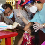 
              In this photo released by Xinhua News Agency, a health worker collects swab sample from a girl for nucleic acid testing in Xianyou county, Putian city, southeastern China's Fujian Province Thursday, Sept. 16, 2021. China has reported another 62 cases of COVID-19, even as the number of Chinese citizens fully vaccinated has topped 1 billion. (Wei Peiquan/Xinhua via AP)
            