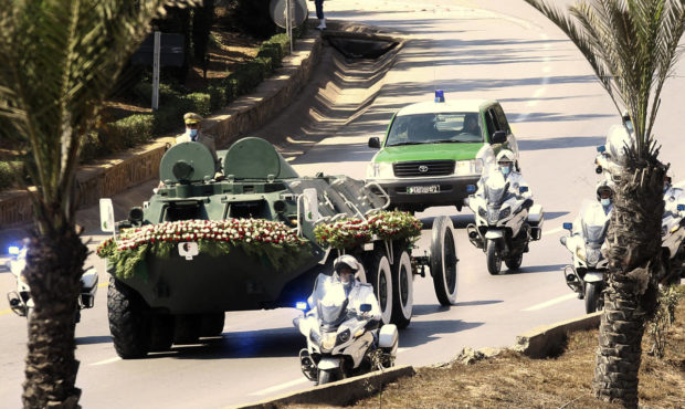 The convoy carrying the coffin of former Algerian President Abdelaziz Bouteflika drives on its way ...