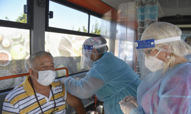 FILE - In this Sept. 4, 2021, file photo, a man receives the Johnson & Johnson vaccine in a bus tha...
