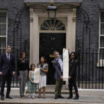 
              Imprisoned British-Iranian woman Nazanin Zaghari-Ratcliffe's husband Richard Ratcliffe, second right, and their seven year old daughter Gabriella pose for the media with, from left, Conservative Party MP Tobias Ellwood, Elika Ashoori whose British-Iranian father Anoosheh Ashoori is detained in Iran, and Labour Party MPs Tulip Siddiq and Janet Daby holding a petition outside 10 Downing Street, London, on the day marking 2,000 days since Nazanin Zaghari-Ratcliffe has been detained in Iran, Thursday, Sept. 23, 2021. Zaghari-Ratcliffe was originally sentenced to five years in prison after being convicted of plotting the overthrow of Iran's government, a charge that she, her supporters and rights groups deny. While employed at the Thomson Reuters Foundation, the charitable arm of the news agency, she was taken into custody at the Tehran airport in April 2016 as she was returning home to Britain after visiting family. (AP Photo/Matt Dunham)
            
