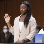 
              United States Olympic gymnast Simone Biles is sworn in during a Senate Judiciary hearing about the Inspector General's report on the FBI's handling of the Larry Nassar investigation on Capitol Hill, Wednesday, Sept. 15, 2021, in Washington. Nassar was charged in 2016 with federal child pornography offenses and sexual abuse charges in Michigan. He is now serving decades in prison after hundreds of girls and women said he sexually abused them under the guise of medical treatment when he worked for Michigan State and Indiana-based USA Gymnastics, which trains Olympians. (Saul Loeb/Pool via AP)
            