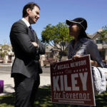 
              Assemblyman Kevin Kiley, left, of Rocklin, a Republican candidate for governor in the Sept. 14 recall election, speaks with supporter Nancy Jiang during a campaign stop outside of Manual Arts High School, Monday, Sept. 13, 2021, in Los Angeles. (AP Photo/Marcio Jose Sanchez)
            