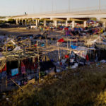 
              Migrants, many from Haiti, are seen in an encampment near the Del Rio International Bridge, Friday, Sept. 24, 2021, in Del Rio, Texas. (AP Photo/Julio Cortez)
            