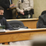 
              Deputy District Attorney Chris Peuvrelle, left and San Luis Obispo County Sheriff's Office detective Clint Cole listen to Judge Craig van Rooyen in a San Luis Obispo, Calif. on Wednesday, Sept. 22, 202. Judge Craig van Rooyen moved to proceed the case towards trial for both Paul and Ruben Flores. Paul Flores is accused of murder the case of missing Cal Poly student Kristin Smart with arraignment scheduled for Oct. 20, 2021. Van Rooyen said there was probable cause Paul Flores, 44, killed Smart and that Ruben Flores, 80, helped dispose of her body, which has never been found. (David Middlecamp/The Tribune (of San Luis Obispo) via AP, Pool)
            