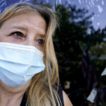 
              In this Monday, Sept. 27, 2021, photo Bronwyn Russell poses for a photo at her home in Des Plaines, Ill. Russell, who has had the COVID-19 vaccine, wears a mask anytime she leaves her Illinois home. “I’m worried. I don’t want to get sick,” says Russell. (AP Photo/Nam Y. Huh)
            
