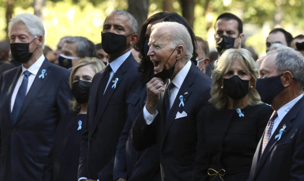 President Joe Biden, center, calls out as he is joined by, from left, former President Bill Clinton...