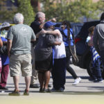 
              People embrace as police respond to the scene of a shooting at a Kroger's grocery store in Collierville, Tenn., on Thursday, Sept. 23, 2021. (Joe Rondone/The Commercial Appeal via AP)
            