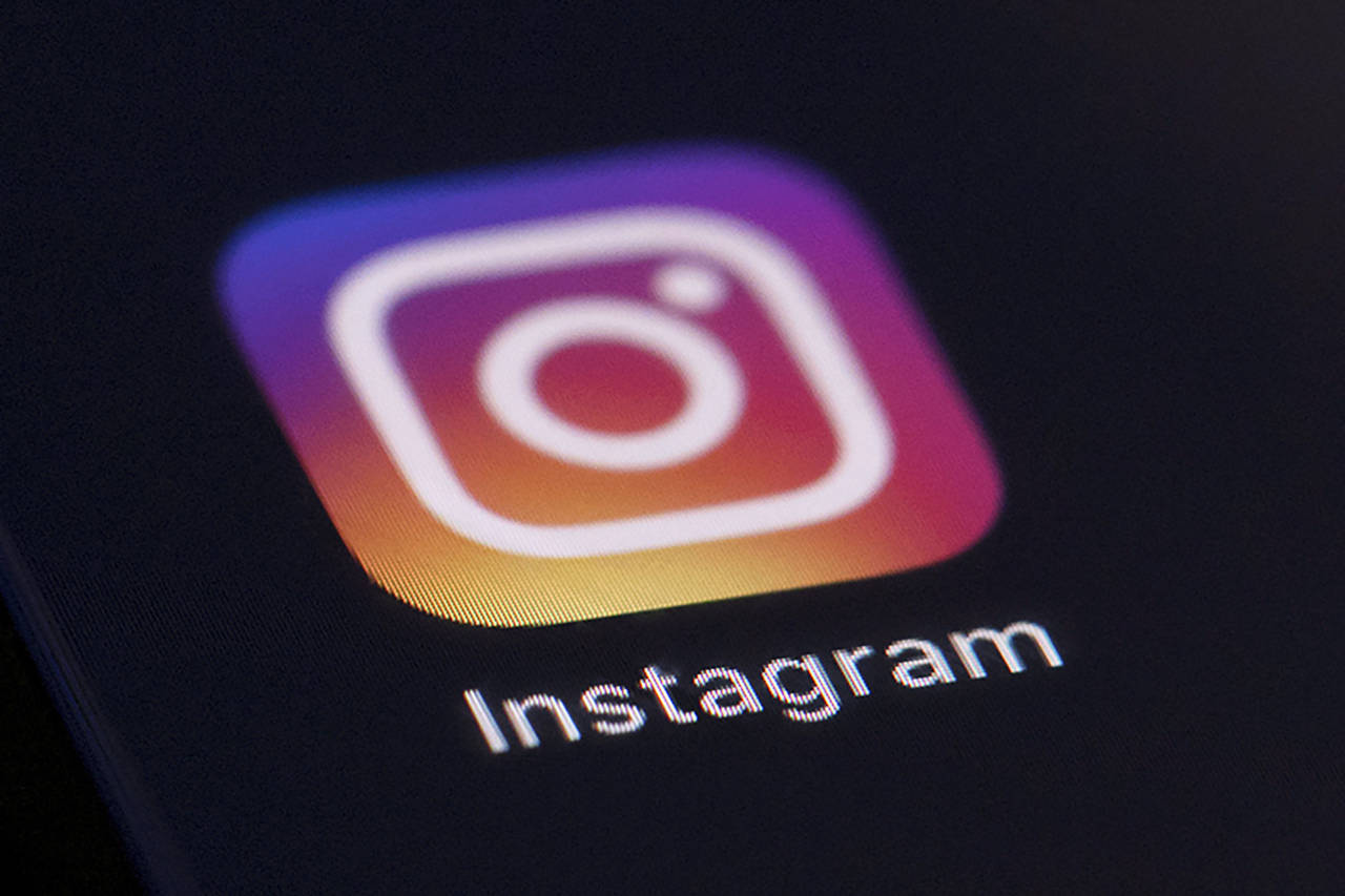 FILE - This Friday, Aug. 23, 2019, file photo shows the Instagram app icon on the screen of a mobil...
