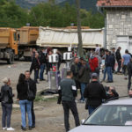 
              Local Serbs stand beside a road blocking the road leading to the northern Kosovo border crossing of Jarinje, Tuesday, Sept. 21, 2021. Tensions soared Monday when Kosovo special police with armored vehicles were sent to the border to impose a rule on temporarily replacing Serb license plates from cars while they drive in Kosovo. (AP Photo/Visar Kryeziu)
            