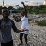 
              Felix Gelin and Claudine Jean describe in sign language how their community, the La Piste encampment, went up in flames this past summer, in Port-au-Prince, Haiti, Sunday, Sept. 20, 2021. According to residents and a United Nations account, police lead the assault at dusk on the encampment, a shelter for deaf and disabled Haitians relocated there by the International Red Cross after the 2010 earthquake leveled the capital. (AP Photo/Rodrigo Abd)
            